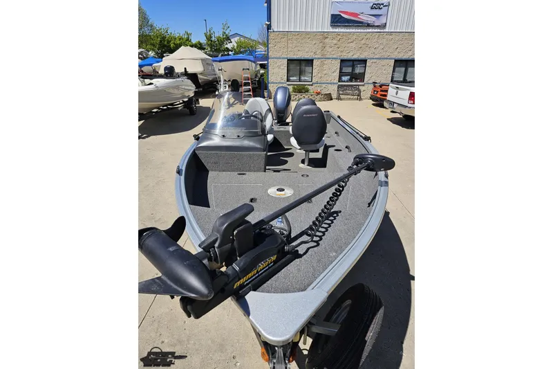 Slide: The Image of 2014 Alumacraft Classic 165 fishing boat with trolling motor, parked outdoors. - 11