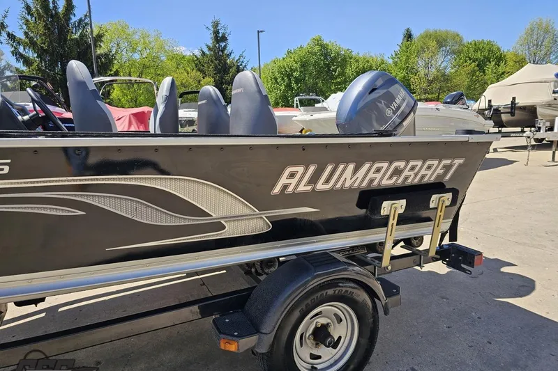 Slide: The Image of 2014 Alumacraft Classic 165 boat on trailer, featuring Yamaha outboard motor. - 21