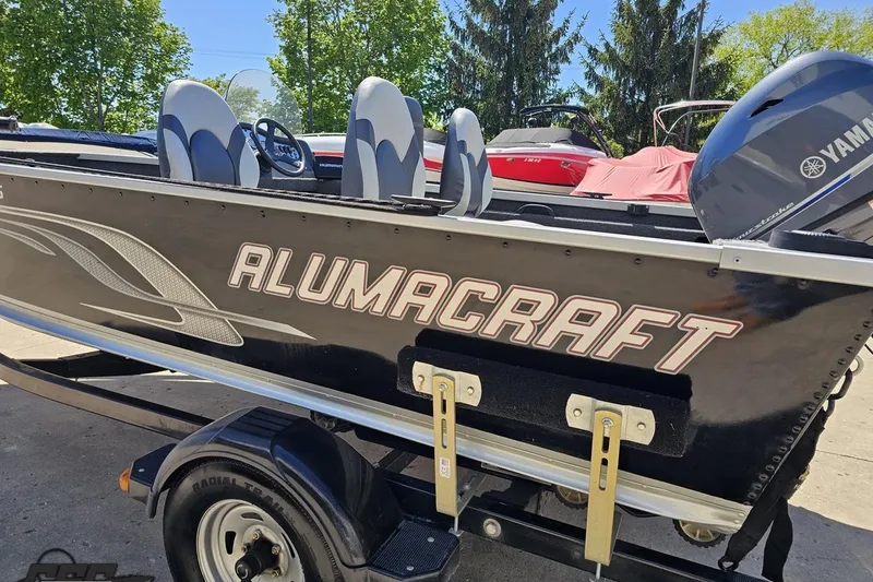 Slide: The Image of 2014 Alumacraft Classic 165 boat with Yamaha motor, parked on a trailer. - 22