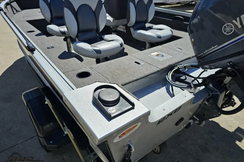 Slide: The Image of 2014 Alumacraft Classic 165 boat interior with Yamaha motor, featuring cushioned seats and storage compartments. - 25