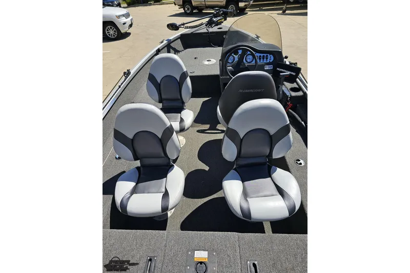 Slide: The Image of 2014 Alumacraft Classic 165 boat interior with four gray seats and control panel. - 29