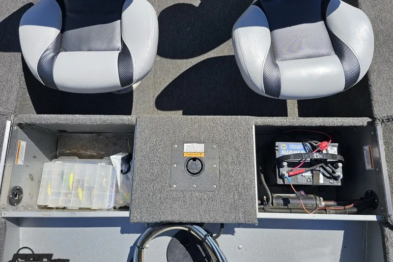 Slide: The Image of 2014 Alumacraft Classic 165 boat interior with seats, battery, and tackle storage. - 31