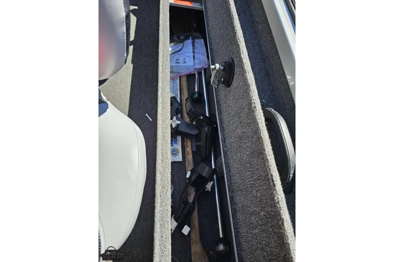Slide: The Image of 2014 Alumacraft Classic 165 boat interior storage compartment with fishing gear. - 38