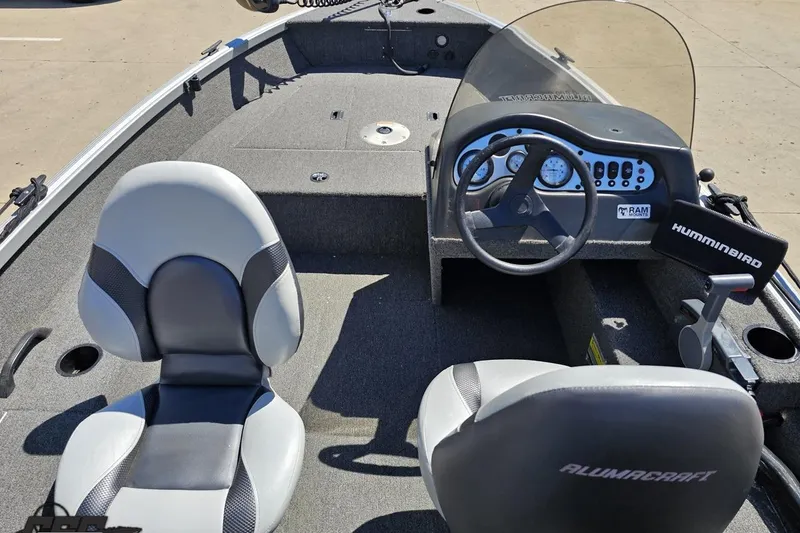 Slide: The Image of 2014 Alumacraft Classic 165 boat interior with steering wheel and seating. - 40