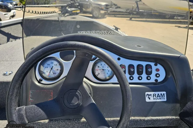 Slide: The Image of 2014 Alumacraft Classic 165 dashboard with steering wheel and instrument panel. - 43