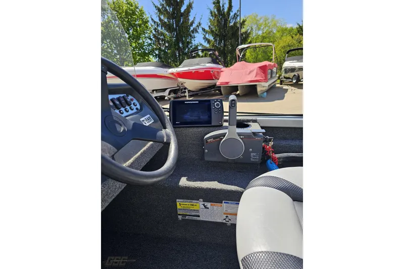 Slide: The Image of 2014 Alumacraft Classic 165 boat dashboard with steering wheel and control panel. - 44