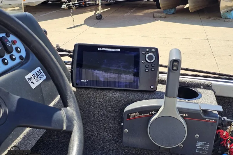 Slide: The Image of 2014 Alumacraft Classic 165 boat dashboard with Humminbird Helix 7 and Yamaha remote control. - 45