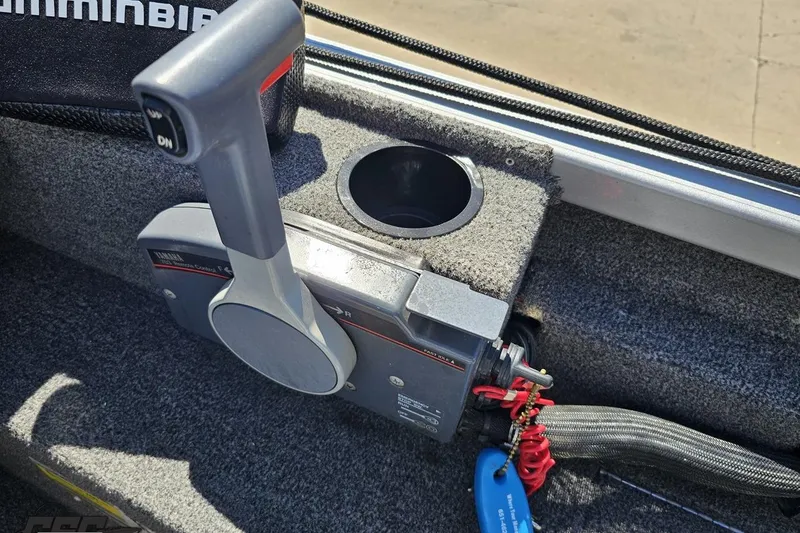 Slide: The Image of Throttle control of a 2014 Alumacraft Classic 165 boat with cup holder. - 46