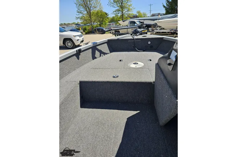 Slide: The Image of 2014 Alumacraft Classic 165 boat interior with carpeted deck and fishing equipment. - 47
