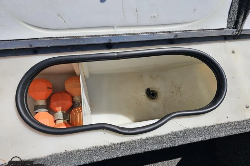 Slide: The Image of Storage compartment in a 2014 Alumacraft Classic 165 boat with orange buoys. - 50