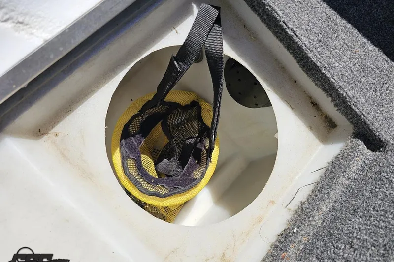 Slide: The Image of Storage compartment in 2014 Alumacraft Classic 165 boat with yellow mesh bag. - 51