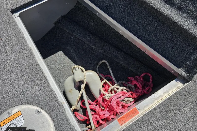 Slide: The Image of Open storage compartment in 2014 Alumacraft Classic 165 boat with ropes and anchor. - 53