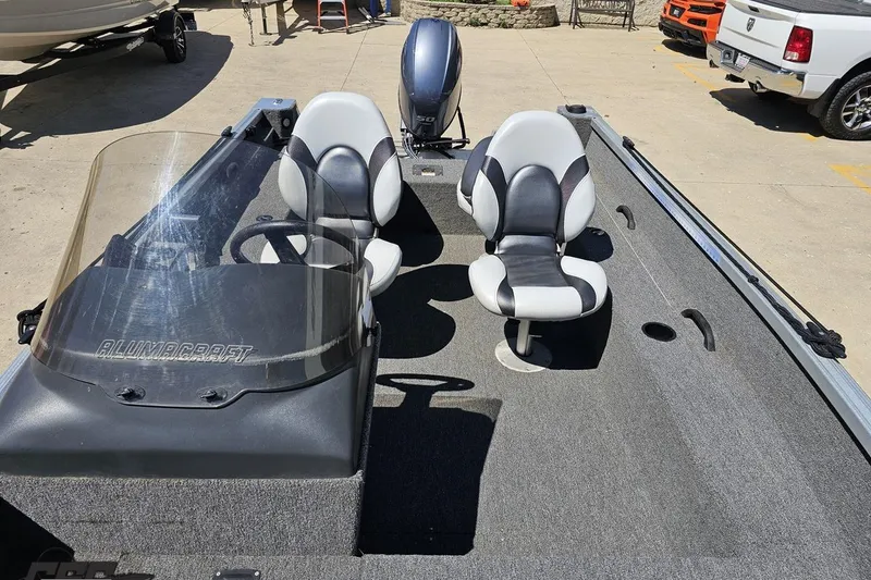 Slide: The Image of 2014 Alumacraft Classic 165 boat interior with two seats and steering console. - 58