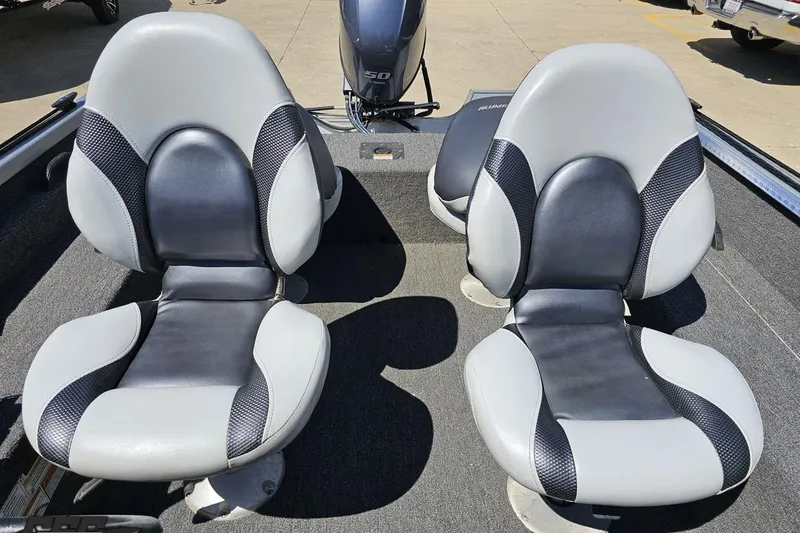 Slide: The Image of 2014 Alumacraft Classic 165 boat interior with two gray and black seats. - 59