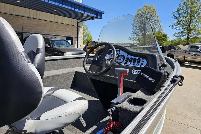 Slide: The Image of 2014 Alumacraft Classic 165 boat interior with steering wheel and dashboard controls. - 6