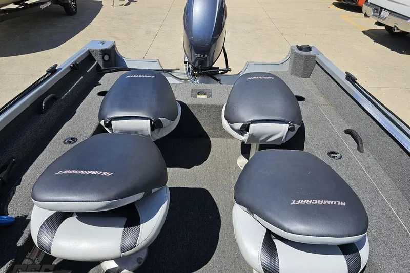 Slide: The Image of 2014 Alumacraft Classic 165 boat interior with four cushioned seats and motor. - 60