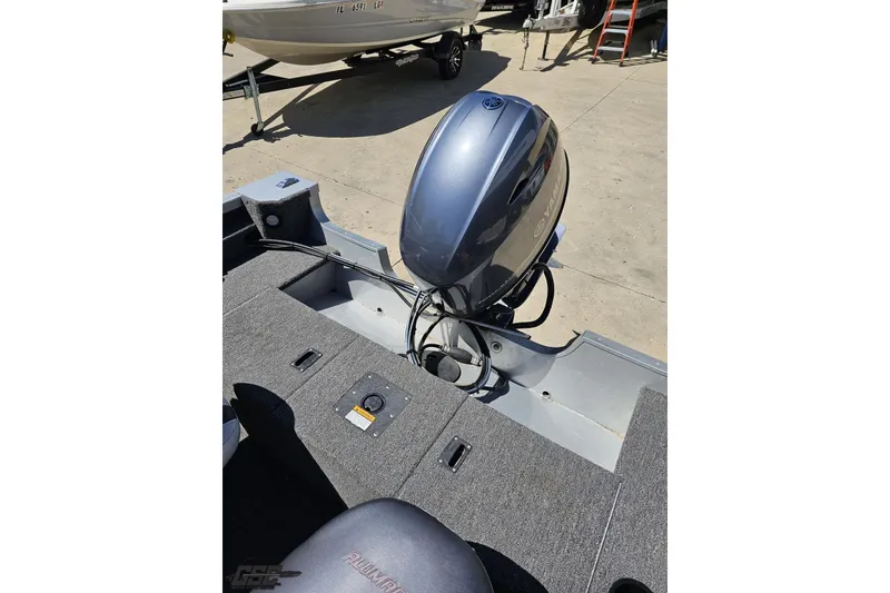 Slide: The Image of 2014 Alumacraft Classic 165 boat with Yamaha outboard motor, parked on concrete surface. - 61
