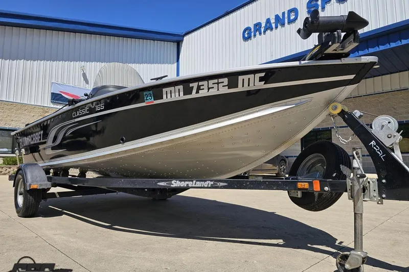 Slide: The Image of 2014 Alumacraft Classic 165 boat on trailer outside Grand Sport building. - 8
