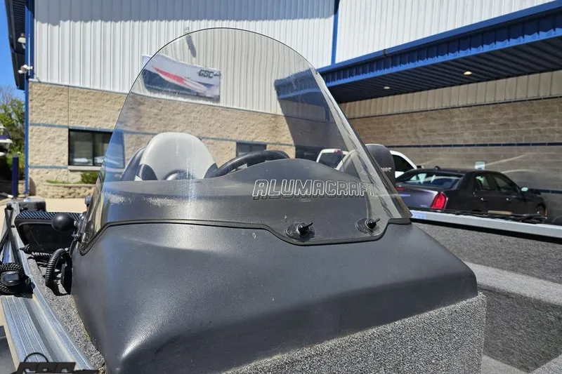 Slide: The Image of 2014 Alumacraft Classic 165 boat windshield in a dealership setting. - 9