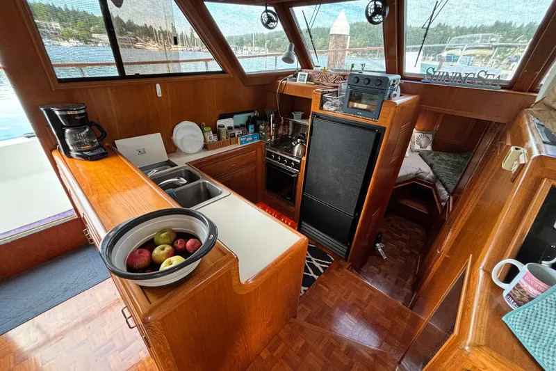Slide: The Image of Interior of 1992 Ocean Alexander 456 Classicco yacht with kitchen and cozy seating area. - 10