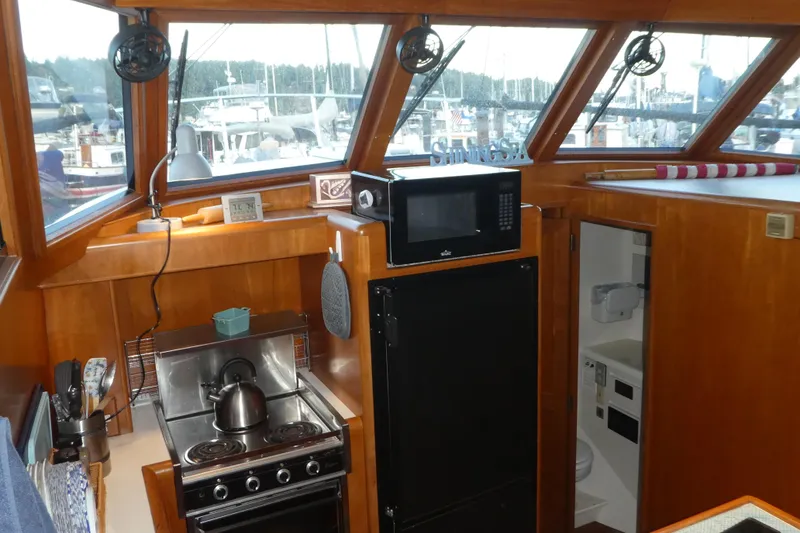 Slide: The Image of Interior of 1992 Ocean Alexander 456 Classicco yacht kitchen with stove, microwave, and fridge. - 18