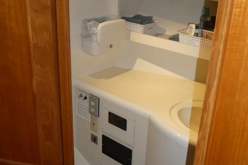 Slide: The Image of Interior of 1992 Ocean Alexander 456 Classicco yacht bathroom with sink and storage. - 23