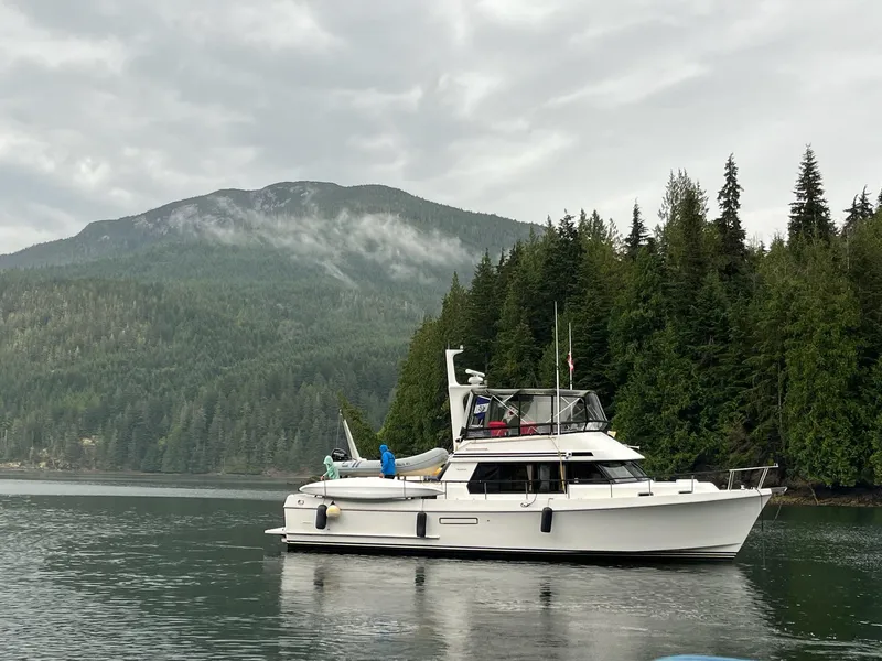 Slide: The Image of 1992 Ocean Alexander 456 Classicco yacht near forested mountains. - 3