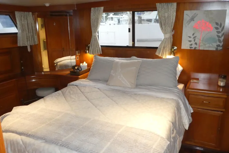 Slide: The Image of Cozy bedroom interior of 1992 Ocean Alexander 456 Classicco yacht with wooden furnishings. - 30