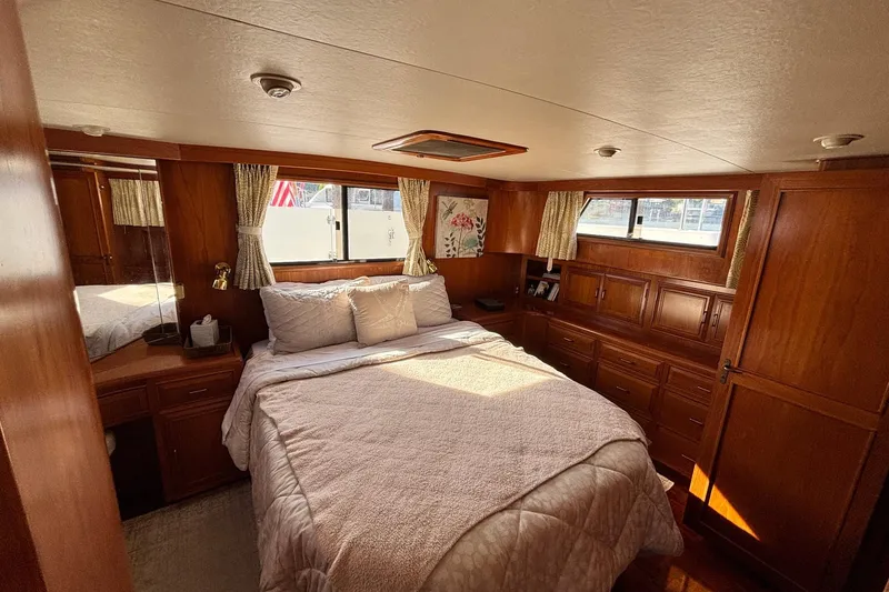 Slide: The Image of Luxurious 1992 Ocean Alexander 456 Classicco yacht bedroom with wood paneling and cozy bedding. - 34