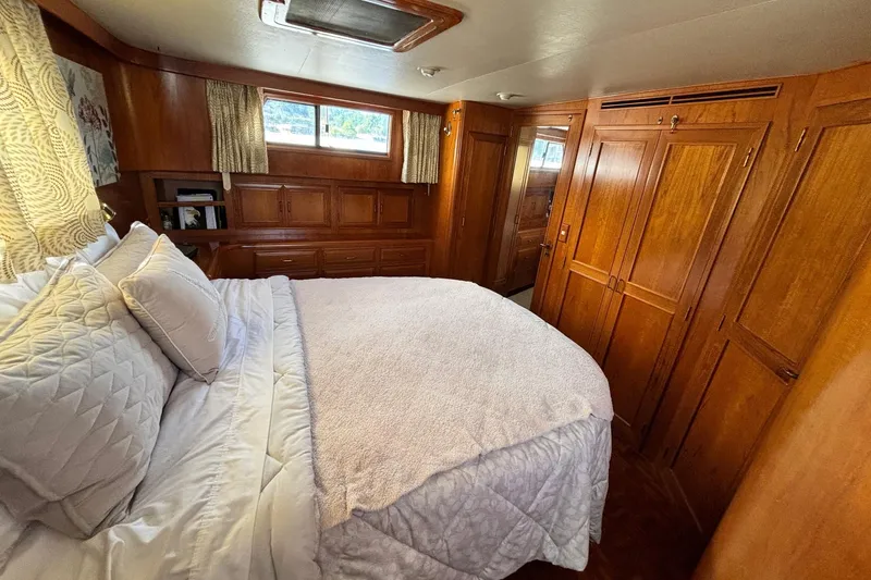 Slide: The Image of Luxurious bedroom interior of 1992 Ocean Alexander 456 Classicco yacht with wooden cabinetry. - 40