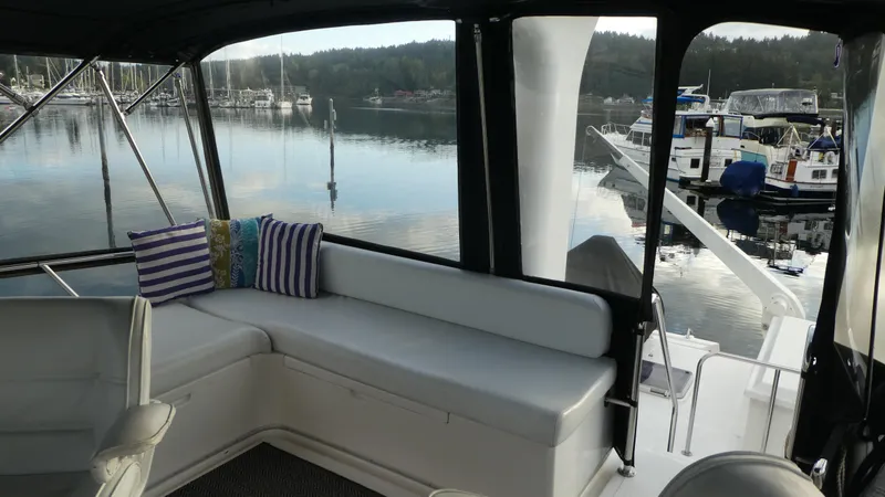 Slide: The Image of Interior view of 1992 Ocean Alexander 456 Classicco yacht with seating and marina backdrop. - 44
