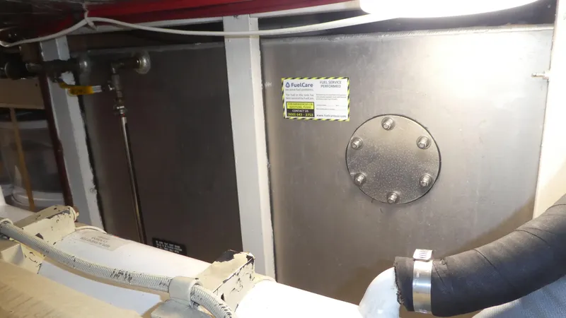 Slide: The Image of Engine room of 1992 Ocean Alexander 456 Classicco yacht, showing metal tank and pipes. - 56