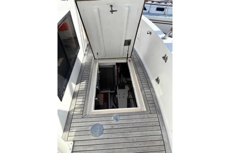 Slide: The Image of Open hatch on 1992 Ocean Alexander 456 Classicco yacht deck, revealing interior compartment. - 58