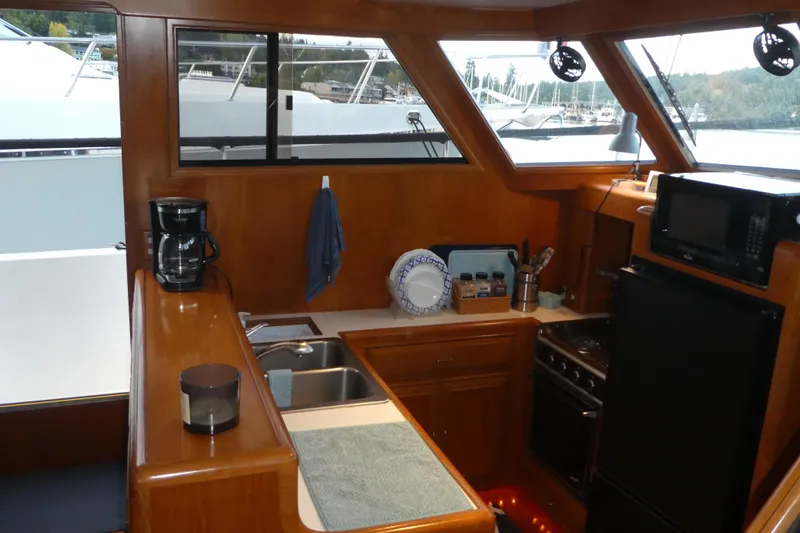 Slide: The Image of Interior of 1992 Ocean Alexander 456 Classicco yacht kitchen with appliances and wooden cabinetry. - 9
