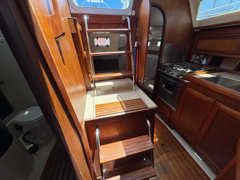 Slide: The Image of Interior of 1992 Hunter Legend 375 sailboat with wooden cabinetry and compact kitchen. - 23