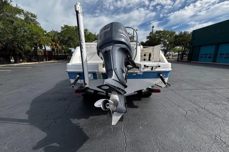 Slide: The Image of 2012 Robalo R227 Dual Console boat with Yamaha outboard motor in a parking lot. - 3