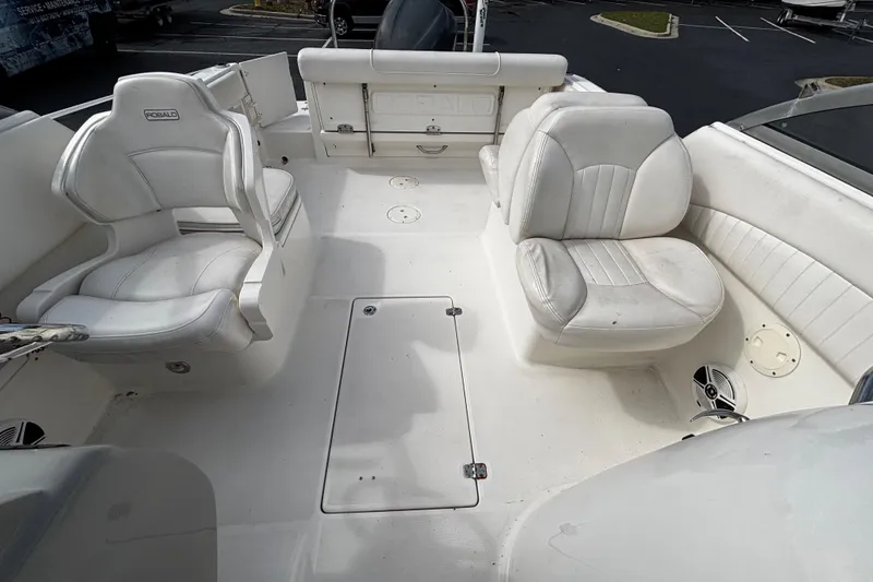 Slide: The Image of 2012 Robalo R227 Dual Console boat interior with white seating and spacious layout. - 5