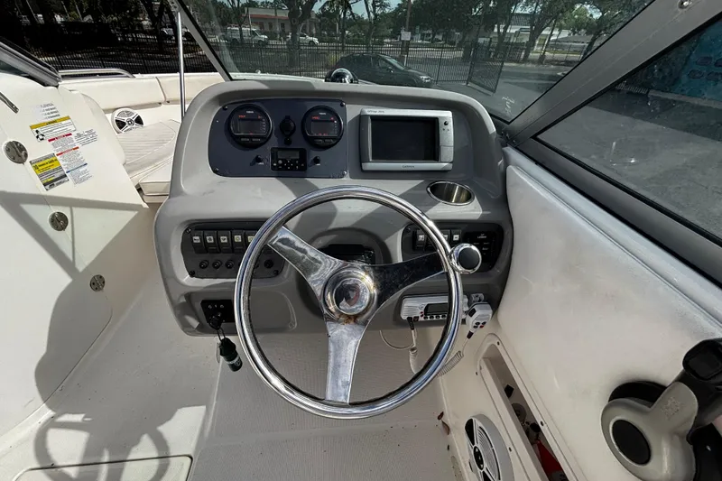 Slide: The Image of 2012 Robalo R227 Dual Console boat dashboard with steering wheel and navigation controls. - 8