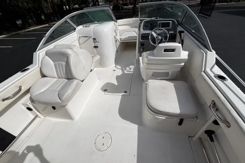 Slide: The Image of 2012 Robalo R227 Dual Console boat interior with white seating and steering console. - 9
