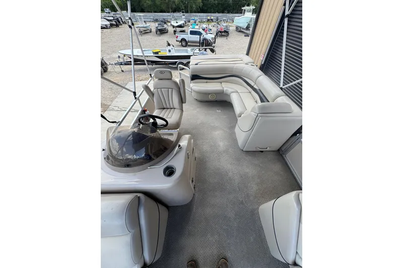 Slide: The Image of 2011 Veranda Tritoon boat interior with spacious seating and steering console. - 10