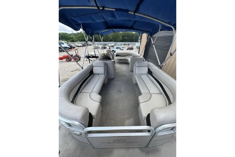 Slide: The Image of 2011 Veranda Tritoon boat with blue canopy and spacious seating. - 11