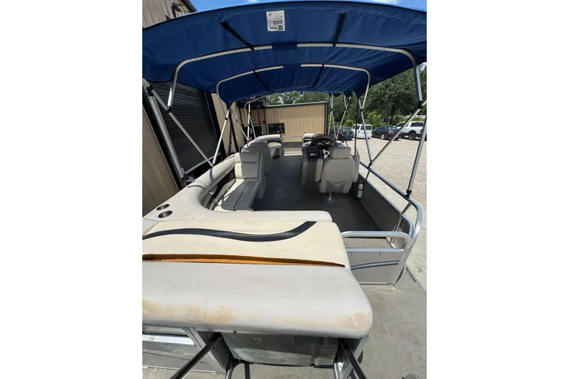 Slide: The Image of 2011 Veranda Tritoon boat with blue canopy and spacious seating area. - 12