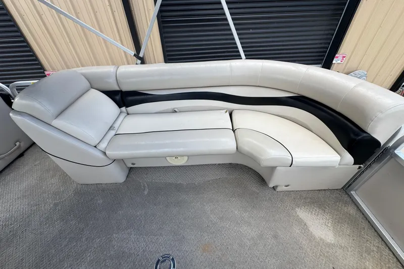 Slide: The Image of 2011 Veranda Tritoon boat interior with beige and black seating arrangement. - 13