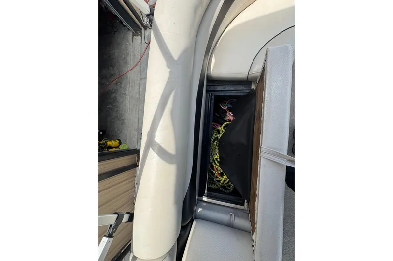 Slide: The Image of Interior view of a 2011 Veranda Tritoon boat showing storage compartment. - 15