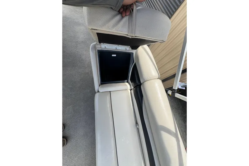 Slide: The Image of 2011 Veranda Tritoon boat seat with open storage compartment. - 18