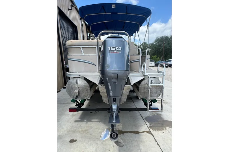 Slide: The Image of 2011 Veranda Tritoon boat with 150 horsepower engine, blue canopy, and aluminum pontoons. - 19