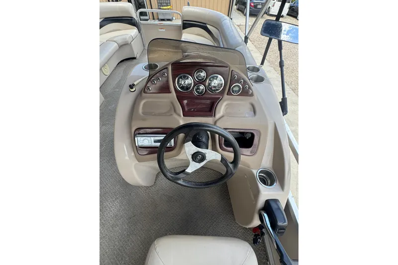 Slide: The Image of 2011 Veranda Tritoon boat dashboard with steering wheel and instrument panel. - 5