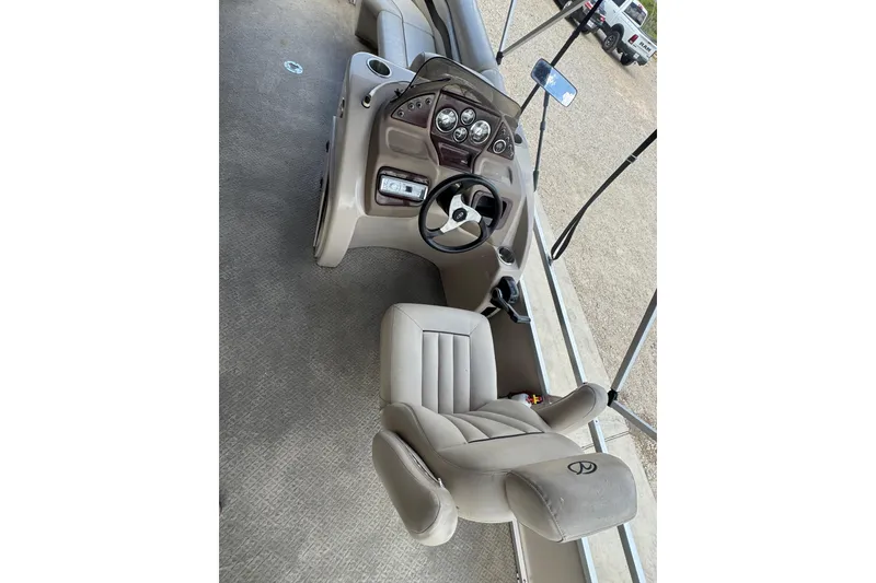 Slide: The Image of 2011 Veranda Tritoon boat interior with steering console and seating. - 6