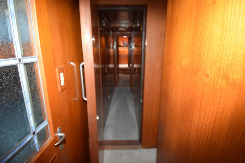 Slide: The Image of Interior hallway of 1988 Sea Ranger 51 Motor Yacht with wooden paneling. - 12