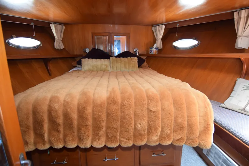 Slide: The Image of Luxurious cabin interior of 1988 Sea Ranger 51 Motor Yacht with plush bedding. - 13